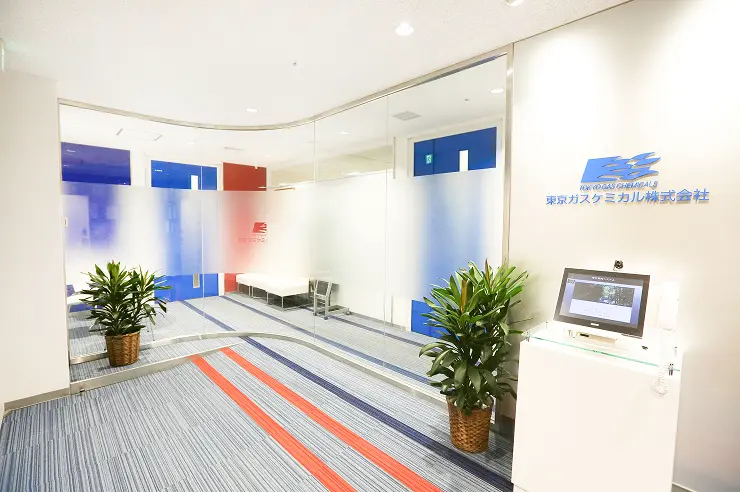 東京ガスケミカル株式会社のエントランス、ガラス張りの壁と受付端末がある清潔感のあるオフィス